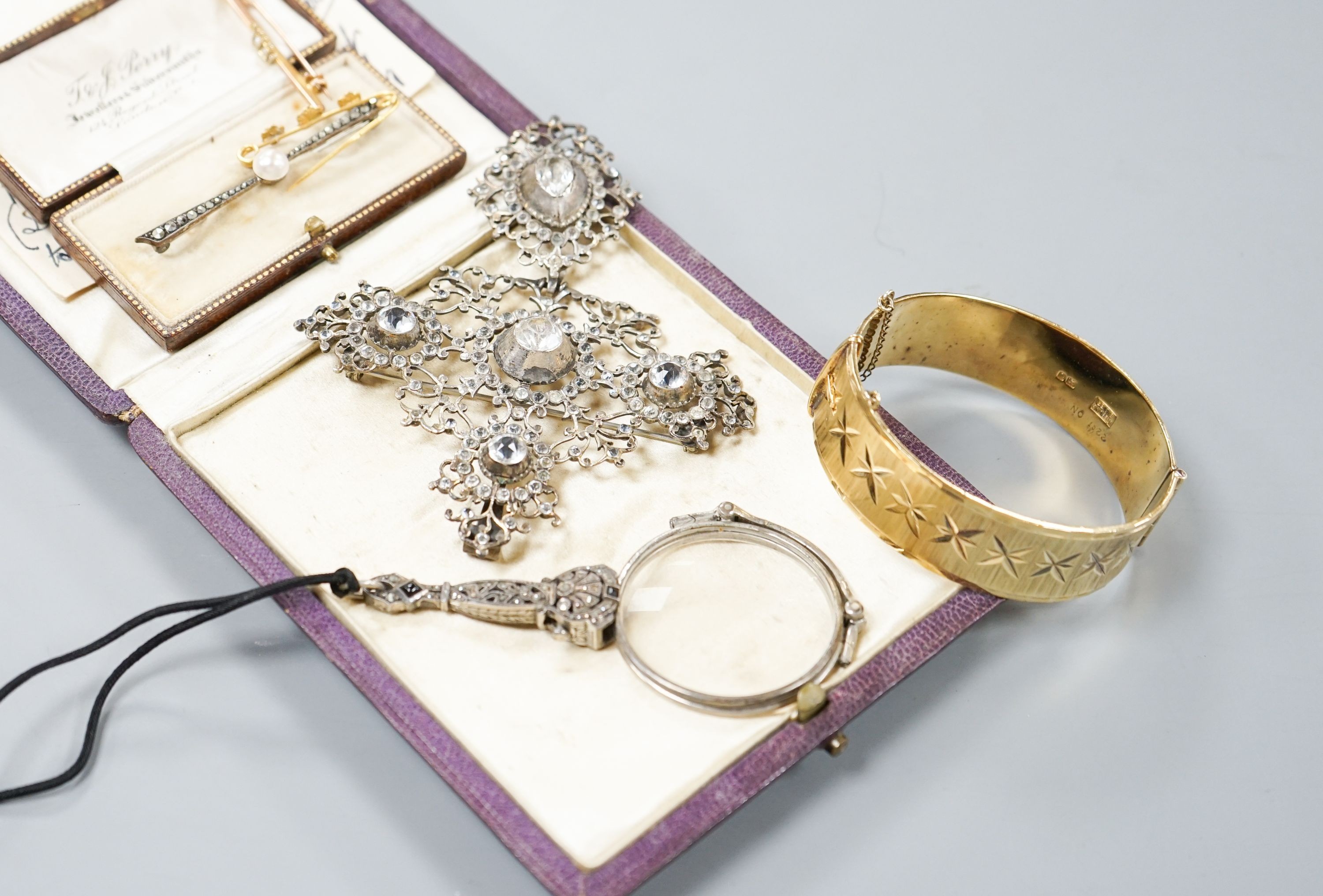 A white metal and paste set drop pendant, 10.7cm, a modern silver gilt bangle, a 9ct gold bar brooch, two other brooches and a marcasite set lorgnettes.